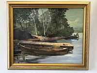 Full view of the framed oil painting showing wooden boat docked by shore, trees, and deer under dawn lighting.
