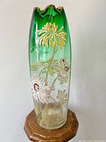 Full front view of vase on wooden stand showing overall shape and ombre coloring