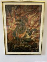 Front view of framed printed silk depicting Fudo Myoo surrounded by flames in a simple gold frame with white matting.
