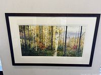 Framed impressionist watercolour painting showing a vibrant autumn forest scene with birch trees.