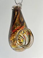 Front angled view showing the circular entrance and swirling brown and amber colors.