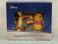 Front view of original packaging with visible salt and pepper shakers inside showing Winnie the Pooh and Tigger figures.