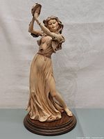 Full view of the porcelain figurine depicting a dancing Gypsy woman holding a tambourine.