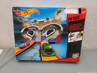 Front of box showing the Hot Wheels Super Speed Blastway dual-track racing playset with cars and launchers.