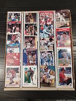 All sports cards in organized rows displaying a variety of sports and years