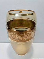 Clear glass Bohemia vase with gold bands and intricate etched details, shown fully upright.