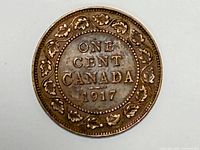 Reverse of 1917 Canadian Large One Cent coin showing denomination, country, date, and maple leaf wreath.