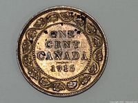 Reverse side of the 1915 Canadian large one cent coin showing denomination, country, date, and decorative wreath.