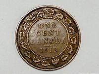 Reverse side showing denomination and date surrounded by maple leaf wreath.
