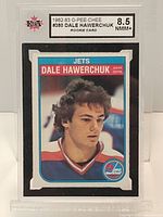 Front of the graded Dale Hawerchuk rookie card showing player photo in Jets jersey, label with grade 8.5 by KSA present on top.