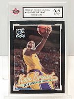 Front of 1996-97 Fleer Ultra #52 Kobe Bryant rookie card in KSA slab, shows action shot and Ultra Rookie logo