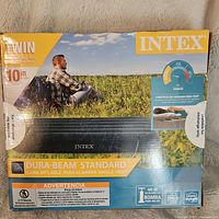 Front view of the closed box showing product brand Intex, model Dura-Beam Standard, twin size and 10 inch height.