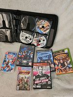 Overview of Nintendo Switch, PlayStation 2 and Xbox games including labeled discs and cases