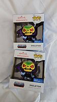 Photo of two new in box Skeletor Funko Pop! Hallmark Christmas ornaments, exclusive to Walmart.