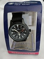 Front view of the Smith & Wesson Field Watch in its original blue and clear display package showing dial and brand name.