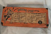 Original orange box with Vitange Mattel Strum-Fun Getar branding and instructions for play and changing song discs.