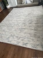 Another angle of Casper area rug spread on the floor showing the full pattern and color tones.