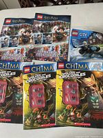 Three LEGO Harry Potter Searching Adventures books, two LEGO Chima Wolves and Crocodiles booklets with mini builds, and a LEGO City set partially visible