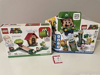 Photo showing LEGO Super Mario Starter Course box with damaged packaging and LEGO Super Mario Expansion Set box in good condition