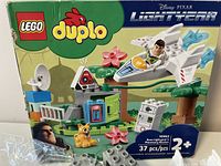 Box front displaying LEGO Duplo Toy Story Buzz Lightyear set with 37 pieces, box art and branding visible.