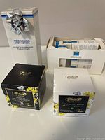 Photo showing two boxed tubs of Helia-D Classic moisturizing creams and one boxed moisturizing body lotion with a silver bow on top.