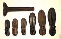 Top down view showing six shoe molds arranged and the stand lying flat