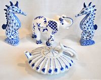 Lot showing all four ceramic pieces including the seahorse pair, the elephant, and the teapot