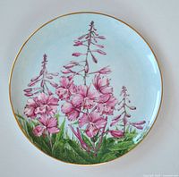 Close-up front view of Yukon Fireweed plate showcasing hand-painted pink flowers with gold edge.