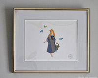 Full framed serigraph print showing Sleeping Beauty with birds and a white mat in a gold-tone frame.