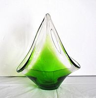 Front view of the hand blown green to clear Murano glass dish showing pointed upward shape and color gradient.