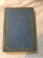 Front cover of the book titled Christmas Stories by Charles Dickens with fading and wear visible.