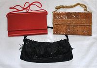 Top view of three evening bags: red satin clutch with strap, brown snakeskin-style clutch with chain, black beaded clutch