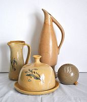 All four pottery items in the lot displayed on a white surface with neutral background, showing scale and relation.