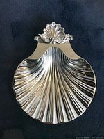 Top view of the footed metal soap dish showing intricate shell shape and decorative top.