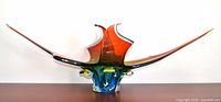 Front view of multicoloured art glass bowl showing elongated asymmetrical horns and base