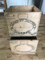 Stacked view of two wooden crates with Canadian Butter Quebec branding.