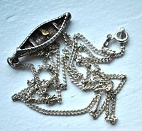 Top view of silver chain laid out showing overall length and pendant shape.