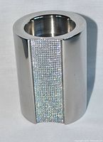 Front view showing polished stainless steel surface with vertical band of clear Swarovski crystals sparkling.