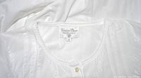 Close-up photo of Victorian Classic brand label 'Victorian Classic by Nancy Charbot' size M sewn inside neckline of white nightgown