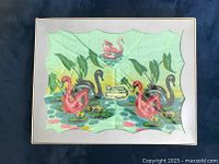 Top view of the towel set inside a windowed box showing a pastel green towel with pink swans and lily pads design. The Kathaway label is visible inside.
