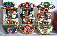 Six wall mountable carousel horses with colorful festive designs and bases labeled Holiday Carousel 1874