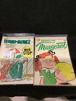 Two Dennis the Menace comic books side by side, one featuring Ruff at a bus stop and the other featuring Margaret.