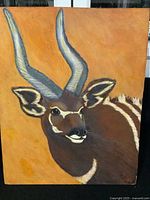 Front view of the painting showing an African Bongo antelope with curved horns on an orange background, signed by the artist.