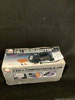Photo of unopened or lightly opened original box of 3-in-1 Mini Air Compressor showing the brand, model and usage images.