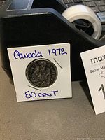 Front side of the coin showing Canadian Coat of Arms and handwritten note 'Canada 1972 50 cent'