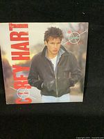 Front cover of the Corey Hart vinyl record album 'Boy in the Box' showing the artist in a black leather jacket with album title text in large red letters.