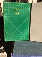 Top view of green Omnigrid cutting mat showing detailed grid lines and size markings