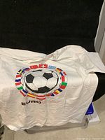 Front view of the white Euro 2008 soccer T-shirt featuring a large black and white soccer ball surrounded by various European country flags and the text 'EURO 2008'.