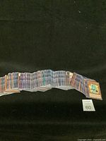 Large spread of Yu-Gi-Oh cards facing up showing various characters and effects.