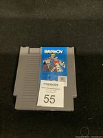 Front of NES Paper Boy game cartridge showing the game label and auction sticker.